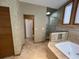 Tile bathroom with soaking tub and walk-in shower; toilet in separate room at 1275 Man O War Dr, Deland, FL 32724