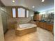 Bright bathroom with soaking tub, glass shower, double vanity sinks and granite countertops at 1275 Man O War Dr, Deland, FL 32724