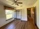 Light bedroom with hardwood floors, open closet, and a view to the yard at 1275 Man O War Dr, Deland, FL 32724