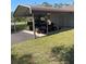 Detached carport featuring space for multiple vehicles and equipment, with a well-maintained lawn at 1275 Man O War Dr, Deland, FL 32724