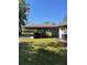 Detached carport featuring space for multiple vehicles, a garage, and well-maintained lawn at 1275 Man O War Dr, Deland, FL 32724