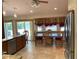 Dining area adjacent to the kitchen with tile flooring, view of the pool, and natural lighting at 1275 Man O War Dr, Deland, FL 32724