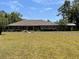 Charming one-story brick home featuring a well-manicured lawn and driveway, nestled among mature trees at 1275 Man O War Dr, Deland, FL 32724