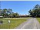 Spacious lot with a well maintained yard, gravel driveway, and lovely, one-story home at 1275 Man O War Dr, Deland, FL 32724