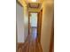 Hallway features wood-look floors leading to an open doorway and rooms, plus a storage closet at 1275 Man O War Dr, Deland, FL 32724