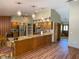 Spacious kitchen showcases an island, modern appliances, and hardwood flooring with open floor plan at 1275 Man O War Dr, Deland, FL 32724