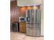 Modern kitchen featuring stainless steel refrigerator and wine cooler with stylish tile flooring at 1275 Man O War Dr, Deland, FL 32724