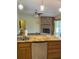 Open concept kitchen with an island featuring granite countertops, sink, and view of living area at 1275 Man O War Dr, Deland, FL 32724