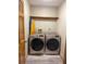 Well-equipped laundry room featuring front-load washer and dryer with wood flooring at 1275 Man O War Dr, Deland, FL 32724