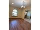 Open living room with hardwood floors, large window, and natural light at 1275 Man O War Dr, Deland, FL 32724