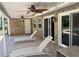 Relaxing covered patio with ceiling fans and lounge chairs overlooking the outdoor area at 1275 Man O War Dr, Deland, FL 32724