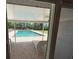 View from covered patio to private backyard pool and outdoor lounging area at 1275 Man O War Dr, Deland, FL 32724