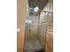 Walk-in shower features tile walls and ceiling, glass door and overhead lighting at 1275 Man O War Dr, Deland, FL 32724