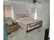 Light-filled main bedroom featuring a modern bed frame, marble floors, and neutral decor at 1416 Aguacate Ct, Orlando, FL 32837
