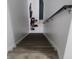 Stairway leading downstairs with modern wooden steps, white walls, and a dark handrail at 1416 Aguacate Ct, Orlando, FL 32837