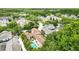 An aerial view of the home and backyard oasis, featuring a pool, spa, and lush landscaping at 1239 Roycroft Ave, Kissimmee, FL 34747