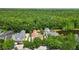 A beautiful aerial view of a private home with a pool, surrounded by lush trees at 1239 Roycroft Ave, Kissimmee, FL 34747