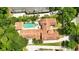 Aerial view shows the home's tile roof, pool, lush landscaping, and proximity to nearby streets at 1239 Roycroft Ave, Kissimmee, FL 34747