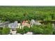 A beautiful aerial view of a private home with a pool, surrounded by lush trees at 1239 Roycroft Ave, Kissimmee, FL 34747