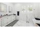 Bright bathroom features double vanity with marble accents, geometric floor tile and a soaking tub at 1239 Roycroft Ave, Kissimmee, FL 34747