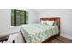 This bedroom is light and airy with wood accents, laminate flooring, and a large window at 1239 Roycroft Ave, Kissimmee, FL 34747
