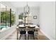 Dining area showcases a modern light fixture and neutral decor with an eye to the backyard at 1239 Roycroft Ave, Kissimmee, FL 34747