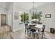 Bright dining area boasts black window trim and a view of the pool and backyard oasis at 1239 Roycroft Ave, Kissimmee, FL 34747