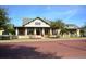 Charming clubhouse features a covered porch, white picket fence, and beautiful landscaping at 1239 Roycroft Ave, Kissimmee, FL 34747