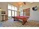 The billiards area features a pool table, comfortable seating, and lots of natural light at 1239 Roycroft Ave, Kissimmee, FL 34747