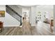 Spacious hallway with beautiful wood-look floors, staircase, and bright, open rooms at 1239 Roycroft Ave, Kissimmee, FL 34747