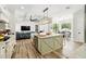 Gourmet kitchen with center island, custom cabinets, stainless appliances, and wood-look floors at 1239 Roycroft Ave, Kissimmee, FL 34747