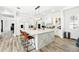 Modern kitchen with large island, white cabinets, stainless steel appliances, and wood-look floors at 1239 Roycroft Ave, Kissimmee, FL 34747
