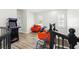 An upstairs landing provides extra living space with arcade game and seating at 1239 Roycroft Ave, Kissimmee, FL 34747