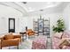 Open-concept living room with stylish seating, a decorative bookcase, and a view of the entryway at 1239 Roycroft Ave, Kissimmee, FL 34747
