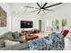 Bright living room features French doors with pool access and an oversized ceiling fan at 1239 Roycroft Ave, Kissimmee, FL 34747