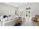 Bright living room with white couch, high ceilings, arched windows, and light wood-look floors at 1239 Roycroft Ave, Kissimmee, FL 34747