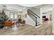 Open-concept living room showcasing stylish seating, a staircase, and modern decor at 1239 Roycroft Ave, Kissimmee, FL 34747