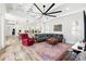 Open-concept floor plan showcases living room connecting to kitchen with modern color accents at 1239 Roycroft Ave, Kissimmee, FL 34747