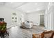 Bright living room featuring white walls, high ceilings, wood beams, and French doors at 1239 Roycroft Ave, Kissimmee, FL 34747