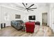 Spacious living room with a vaulted ceiling, wood floors, and a unique oversized ceiling fan at 1239 Roycroft Ave, Kissimmee, FL 34747
