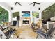 Pool cabana with stone fireplace, outdoor seating, ceiling fans, and views of the lush backyard at 1239 Roycroft Ave, Kissimmee, FL 34747