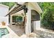 Pool cabana features outdoor seating, ceiling fan, and retractable awning for shade at 1239 Roycroft Ave, Kissimmee, FL 34747