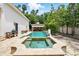 A backyard pool and spa feature stone decking, a cabana, and lush landscaping at 1239 Roycroft Ave, Kissimmee, FL 34747