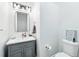 Chic powder room offers a modern mirror and vanity with stylish fixtures and neutral colors at 1239 Roycroft Ave, Kissimmee, FL 34747