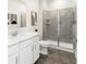 Bright bathroom featuring a glass enclosed shower, modern sink, and stylish wood-look floor at 1967 Rider Rain Ln, Apopka, FL 32703
