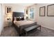 Comfortable bedroom with plush carpet, bench seat, decorative pillows and natural light from the window at 1967 Rider Rain Ln, Apopka, FL 32703