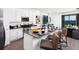 Bright kitchen features white cabinetry, stainless steel appliances, a center island, and seating for three at 1967 Rider Rain Ln, Apopka, FL 32703