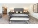 Serene main bedroom features decorative accent wall, bench seat and luxurious bedding at 1967 Rider Rain Ln, Apopka, FL 32703
