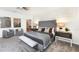 Spacious main bedroom with gray accent wall, bench seating and comfortable seating area at 1967 Rider Rain Ln, Apopka, FL 32703