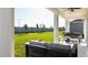 Covered patio with outdoor seating, overlooking a well-maintained backyard and privacy fence at 1967 Rider Rain Ln, Apopka, FL 32703